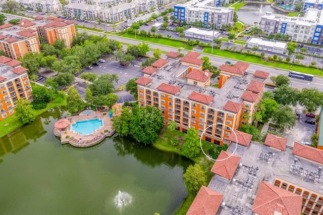an aerial view of a house with a garden and lake view