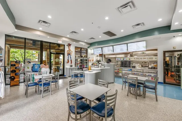 a kitchen with stainless steel appliances granite countertop a stove and a large window