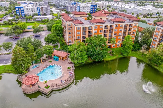 an aerial view of a house with outdoor space and a lake view