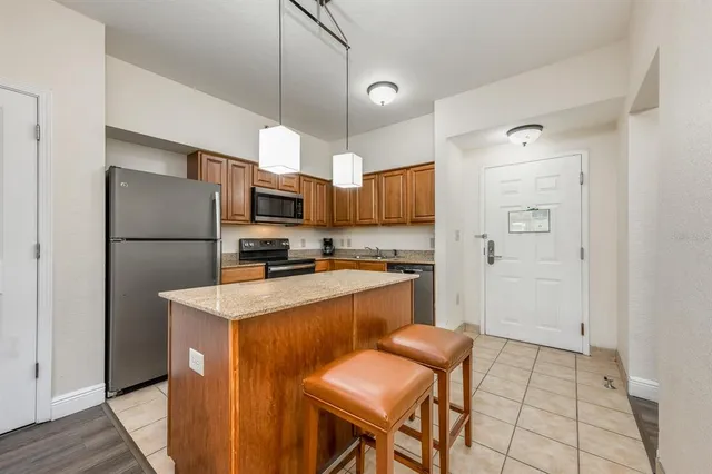 a kitchen with stainless steel appliances a refrigerator stove microwave and cabinets