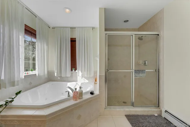 a bathroom with bathtub and shower