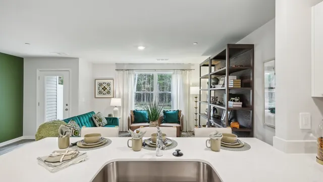 a kitchen with a sink stainless steel appliances and white cabinets
