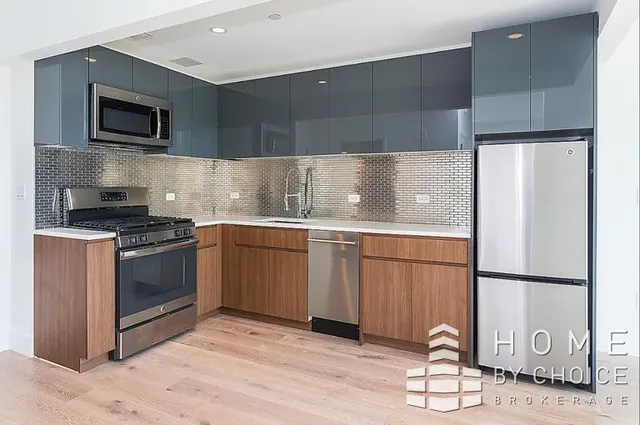 a kitchen with a sink cabinets and stainless steel appliances