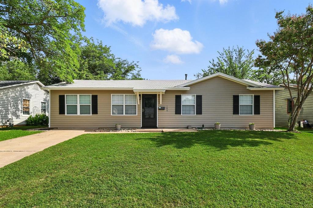 106 Tarrant Drive Euless, TX 76039 - Photo 1 of 1 a front view of a house with a garden