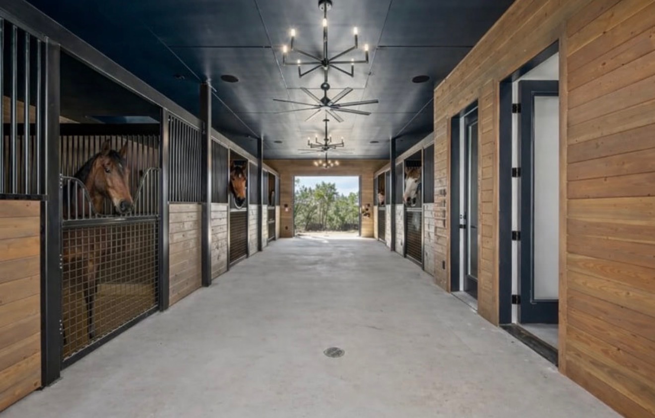 475 Happy Trail Dripping Springs, TX 78620 - Photo 3 of 40 Custom barn interior featuring a 5 stalls, tack room, bathroom. chandeliers, fans and T and G doug fir wood interior, speakers, cameras
