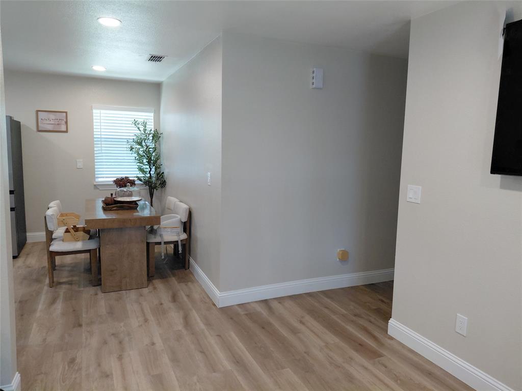 636 Clearfield Road Dallas, TX 75217 - Photo 8 of 10 Dining area featuring wood-finish flooring, recessed lighting, and a window with blinds