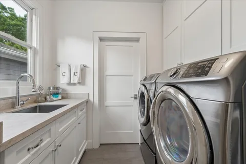 a kitchen with a sink a washer and dryer