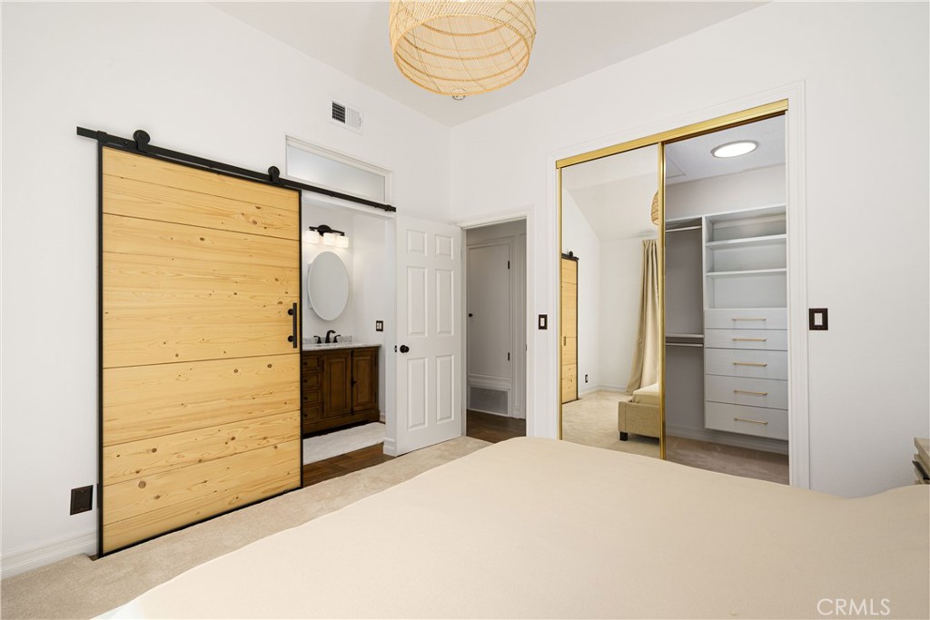 20 Wintermist Irvine, CA 92614 - Photo 16 of 51 a bedroom with a bed and a mirror