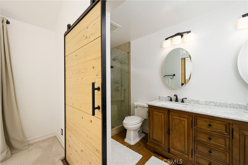 20 Wintermist Irvine, CA 92614 - Photo 18 of 51 a bathroom with a sink a toilet and a mirror