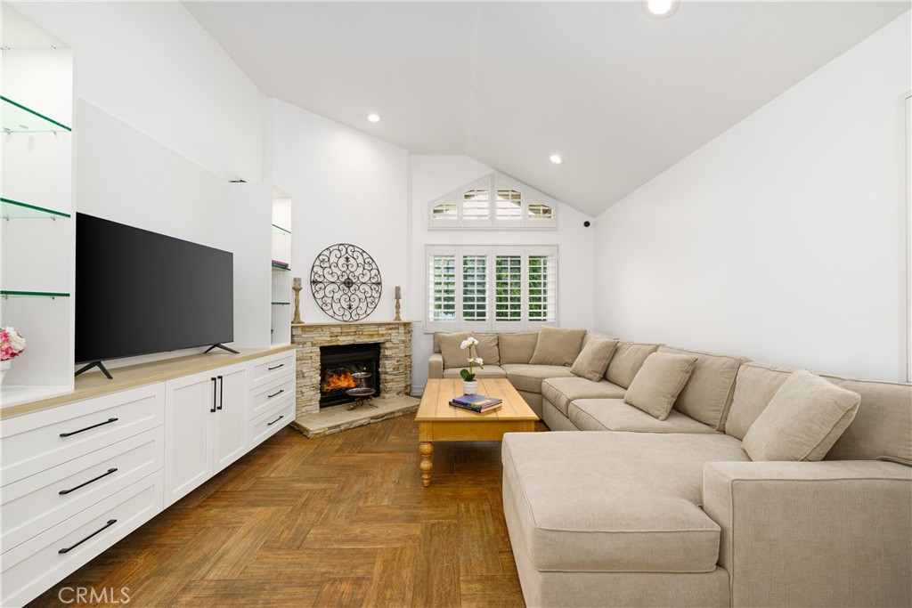 20 Wintermist Irvine, CA 92614 - Photo 2 of 51 a living room with furniture a fireplace and a flat screen tv