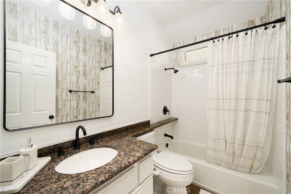 20 Wintermist Irvine, CA 92614 - Photo 21 of 51 a bathroom with a granite countertop sink a toilet and shower