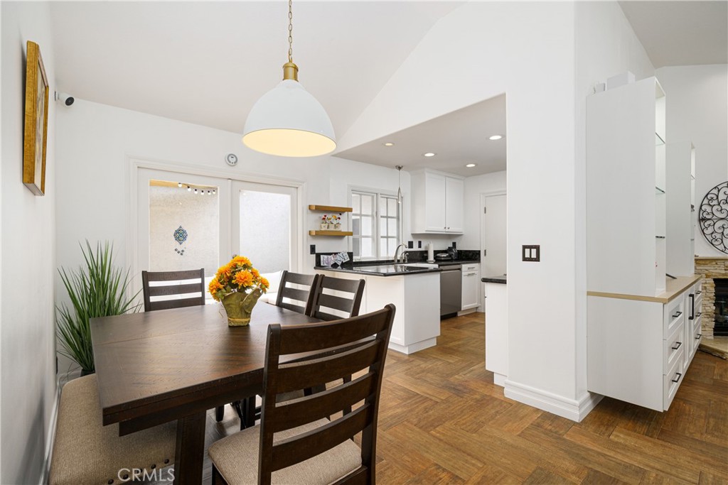 20 Wintermist Irvine, CA 92614 - Photo 8 of 51 a kitchen with a table chairs and white cabinets
