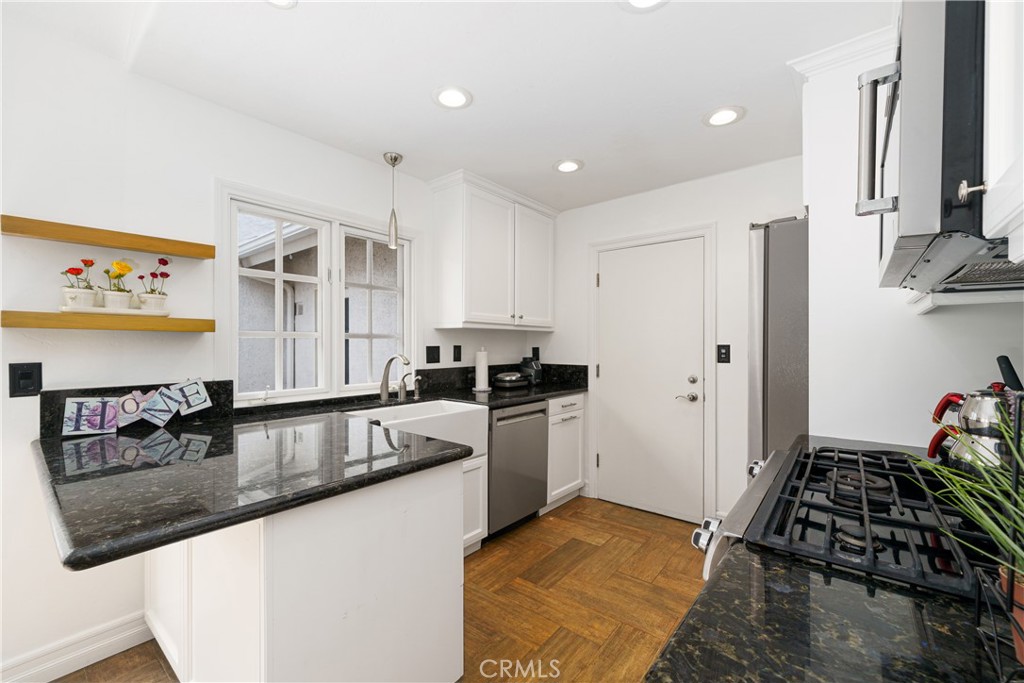 20 Wintermist Irvine, CA 92614 - Photo 10 of 51 a kitchen with stainless steel appliances granite countertop a sink stove and refrigerator