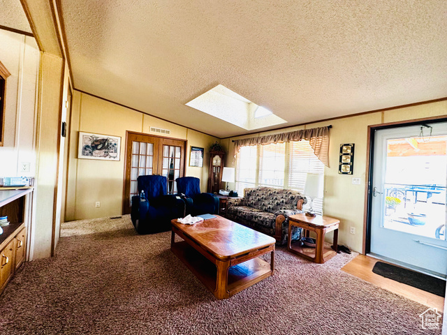 82 Powell Drive, Unit 77 Boulder, UT 84716 - Photo 10 of 16 Living Room with skylight- large windows offering plenty of natural light