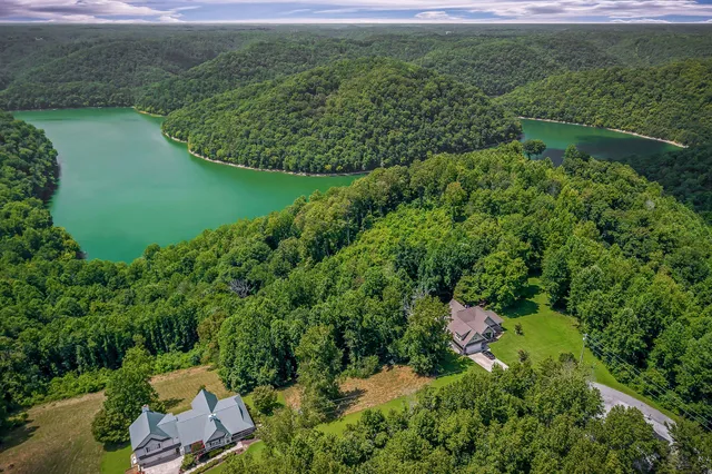 an aerial view of a house with a yard