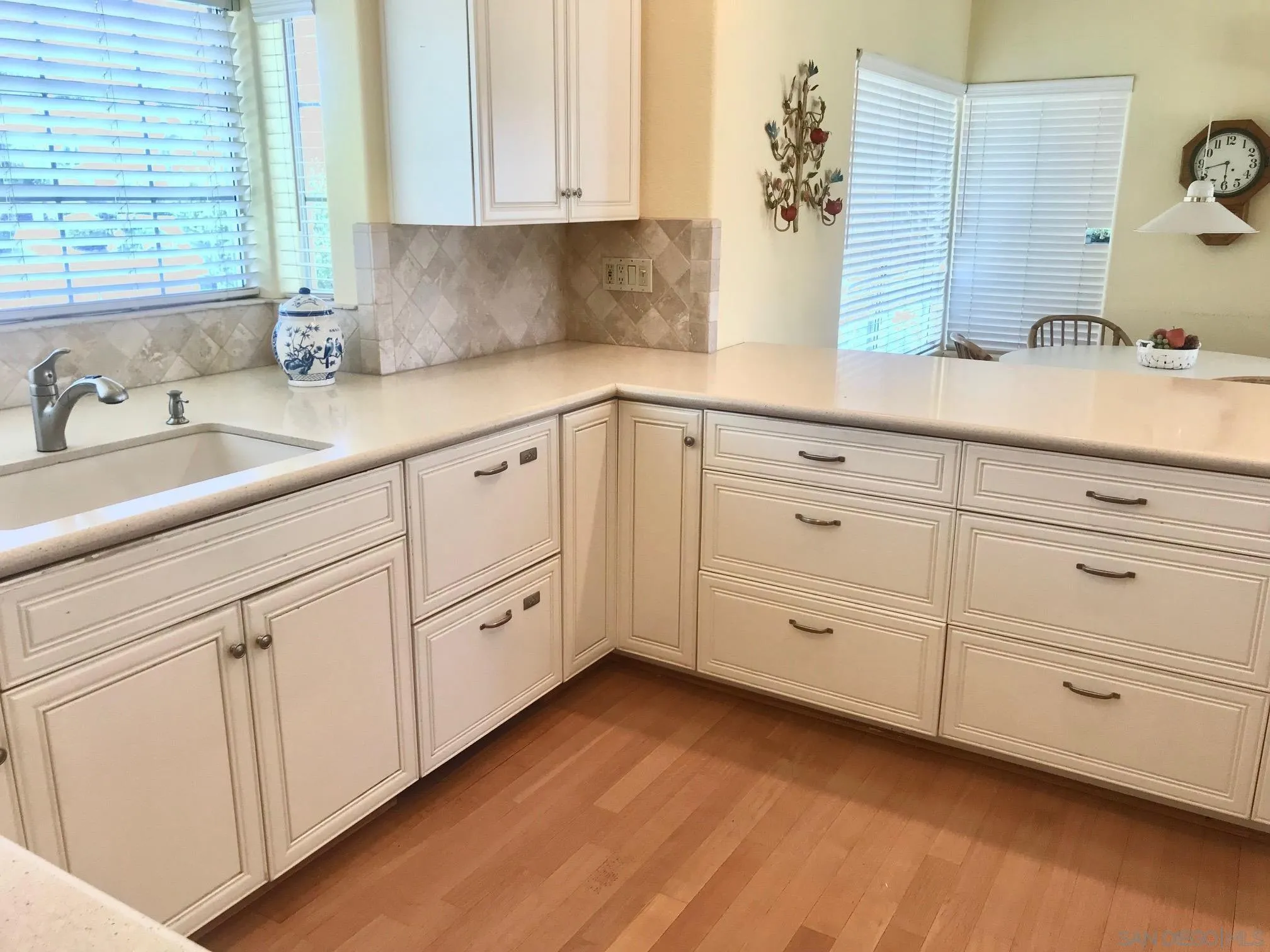 12650 Treehill Place Poway, CA 92064 - Photo 5 of 7 a kitchen with granite countertop white cabinets and white appliances