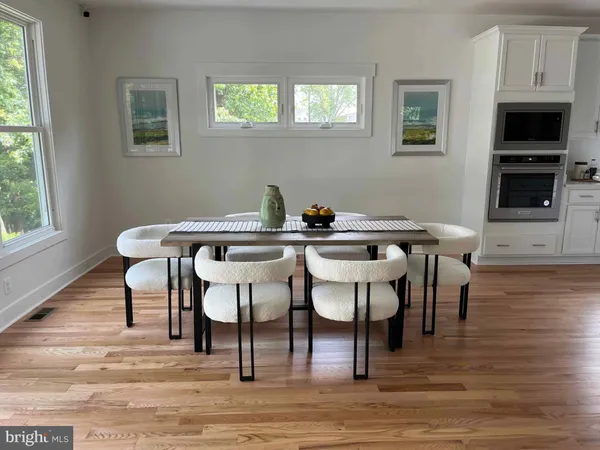 a view of a dining room with furniture and wooden floor