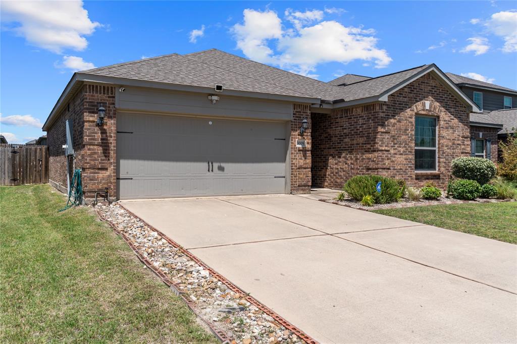 3005 Parker Road Anna, TX 75409 - Photo 1 of 17 Brick exterior featuring a two-car garage with a concrete driveway