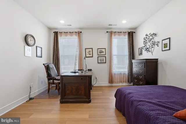 a bedroom with a bed and a desk