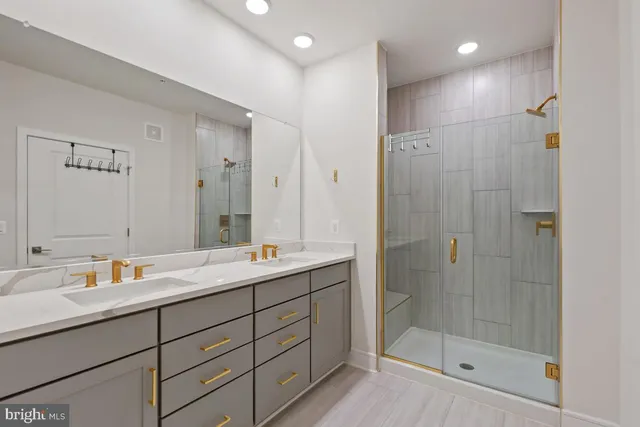 a bathroom with a shower sink and mirror