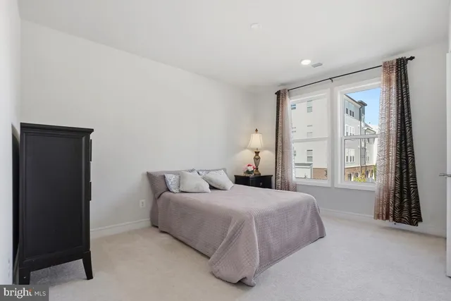 a bedroom with a bed and a large window