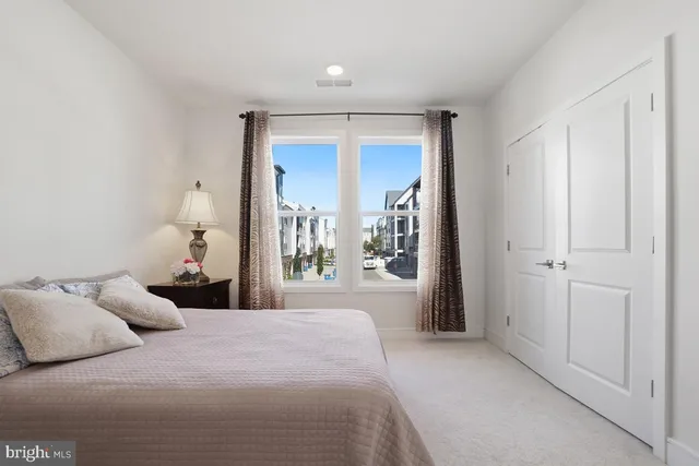 a bedroom with a large bed and a window