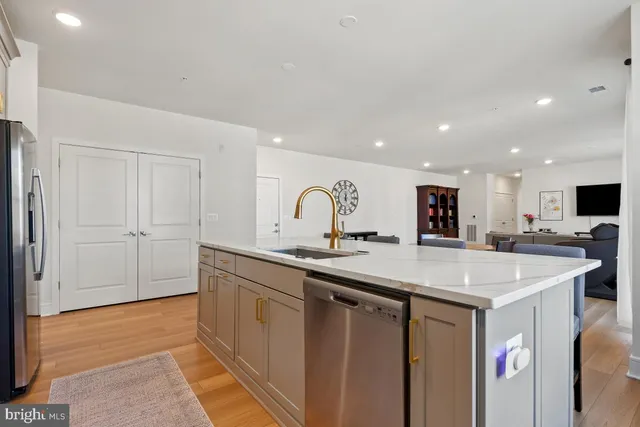 a kitchen with sink and white cabinets