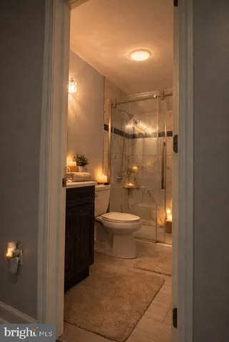a bathroom with a toilet a sink and shower
