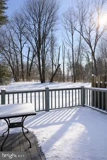 a view of a two chairs and table in the back yard