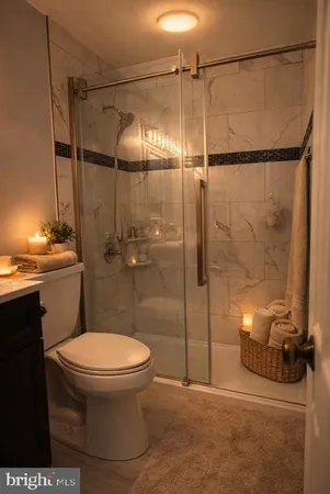 a bathroom with a toilet and a shower