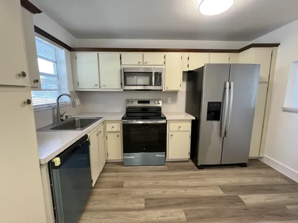 a kitchen with stainless steel appliances a refrigerator stove and sink