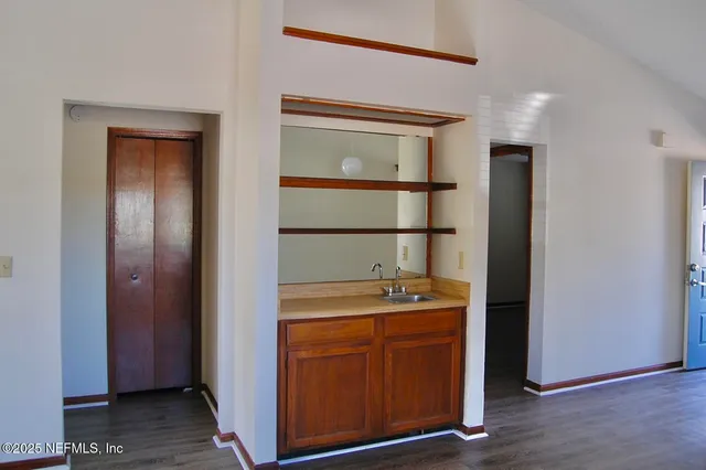 a room with cabinets and wooden floor
