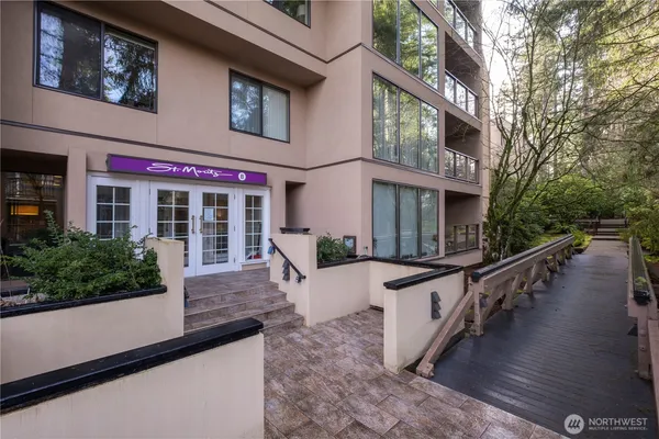 a view of a building with stairs and sitting area