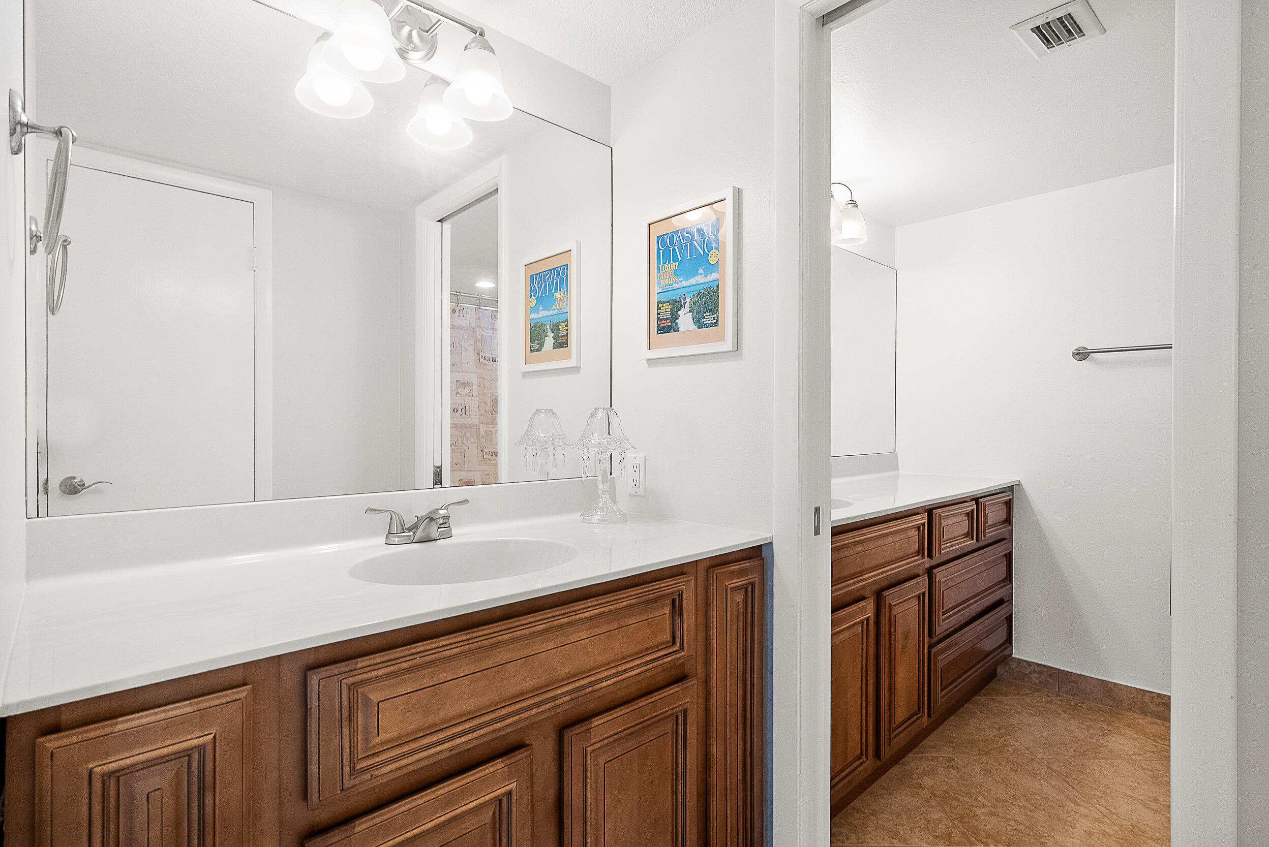 4100 North Hwy A1A, Unit 315 Hutchinson Island, FL 34949 - Photo 20 of 41 a bathroom with double vanity sink and a mirror