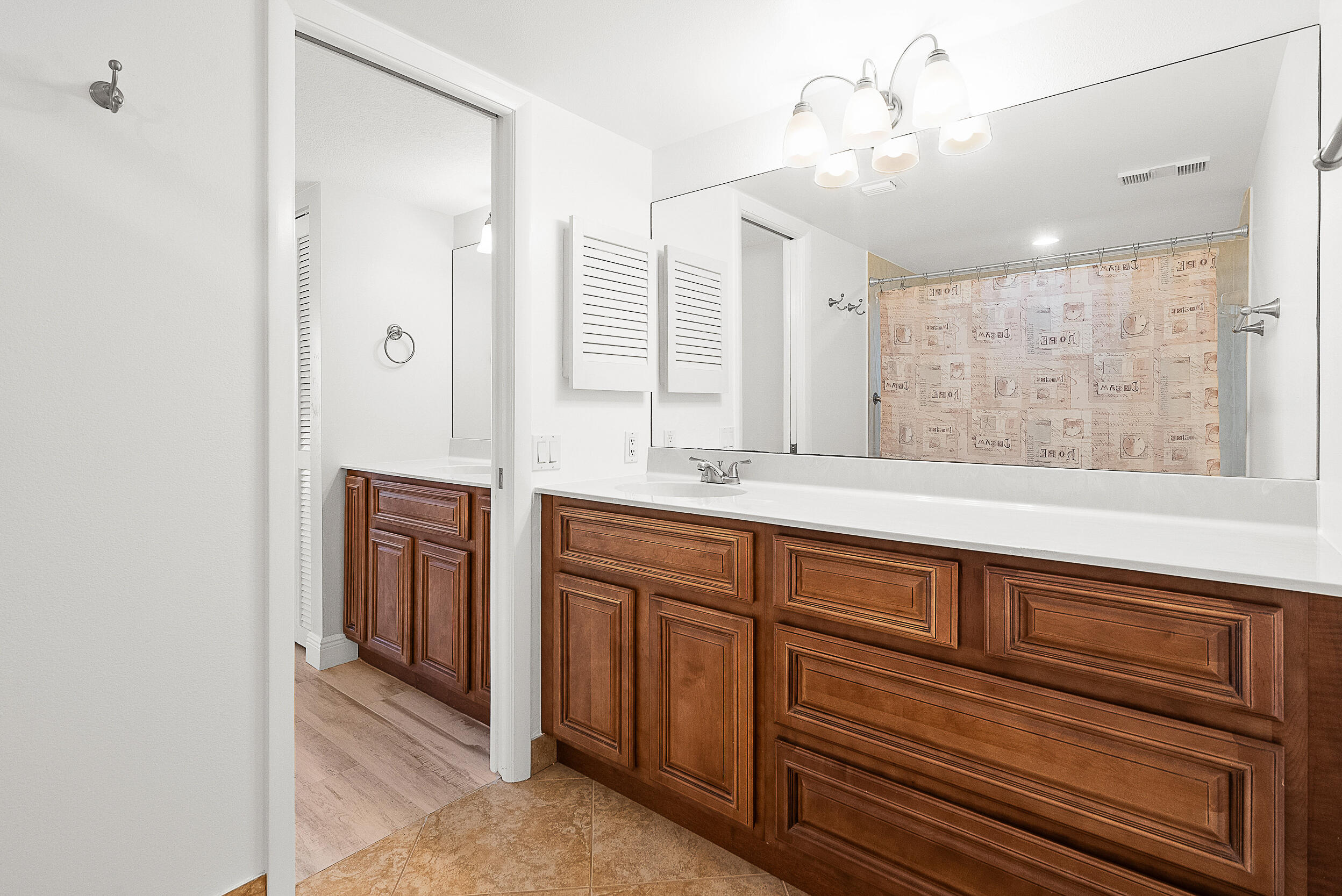 4100 North Hwy A1A, Unit 315 Hutchinson Island, FL 34949 - Photo 21 of 41 a spacious bathroom with a shower a sink and a mirror