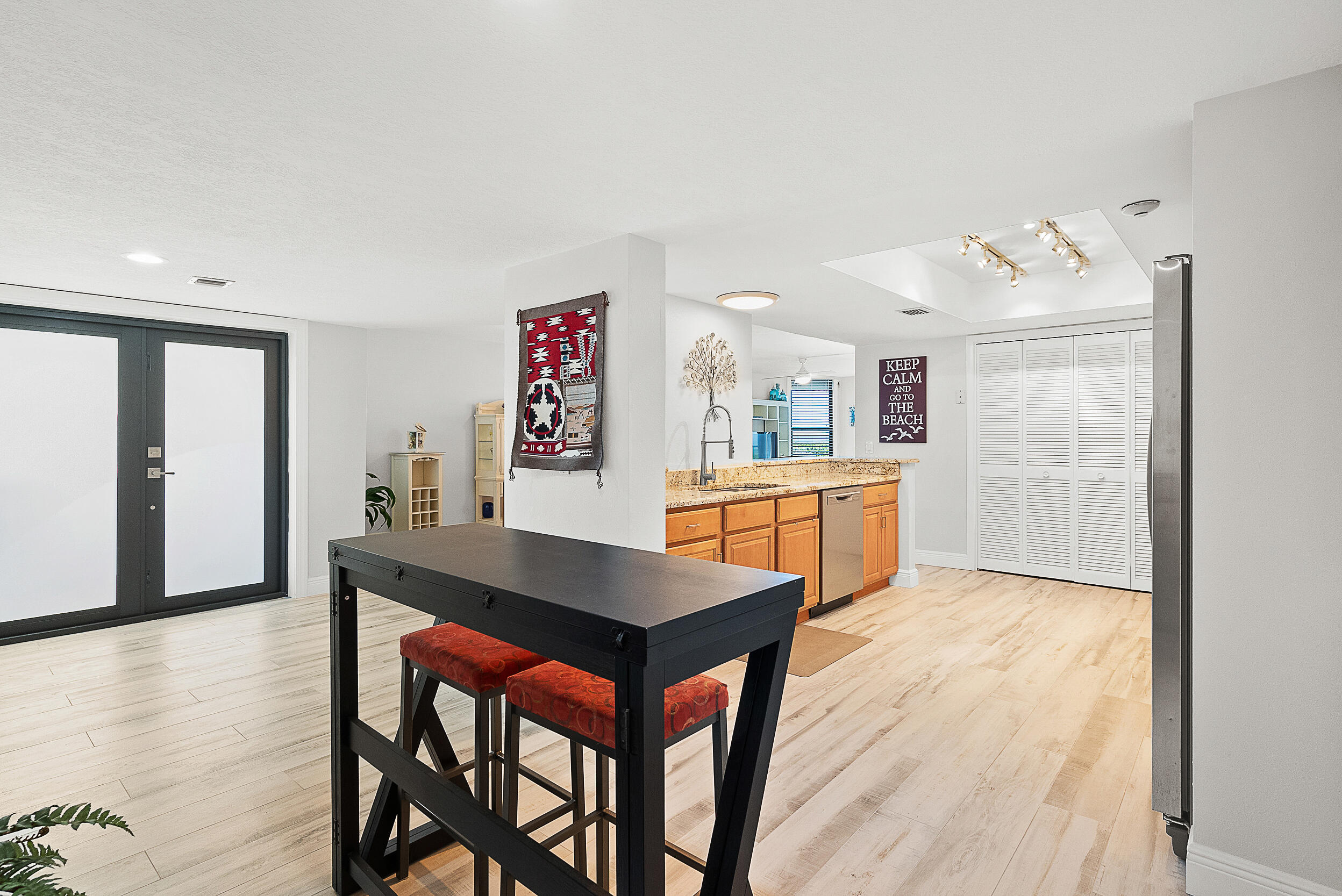 4100 North Hwy A1A, Unit 315 Hutchinson Island, FL 34949 - Photo 23 of 41 a living room with stainless steel appliances kitchen island a table and chairs in it