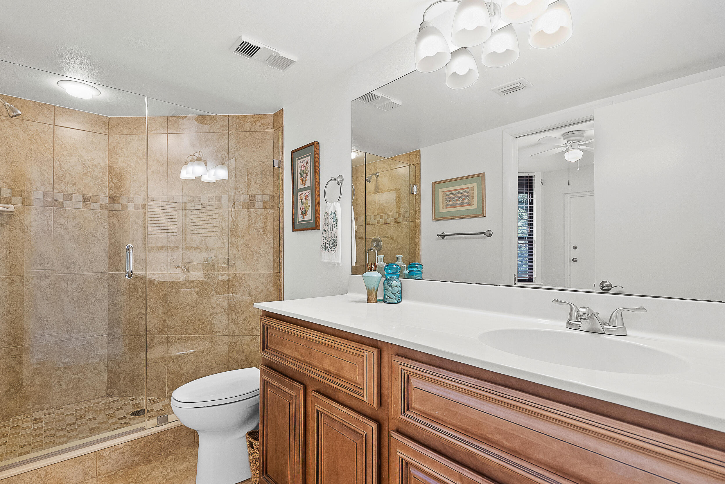 4100 North Hwy A1A, Unit 315 Hutchinson Island, FL 34949 - Photo 27 of 41 a bathroom with a sink a toilet and shower