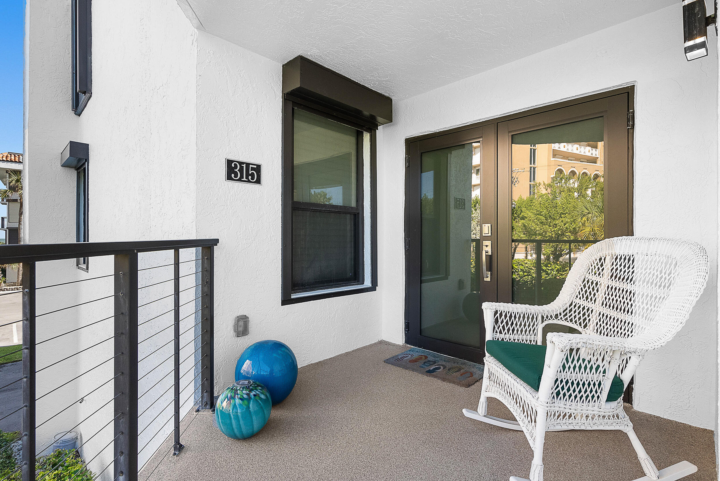 4100 North Hwy A1A, Unit 315 Hutchinson Island, FL 34949 - Photo 31 of 41 a view of a balcony with chair and a potted plant
