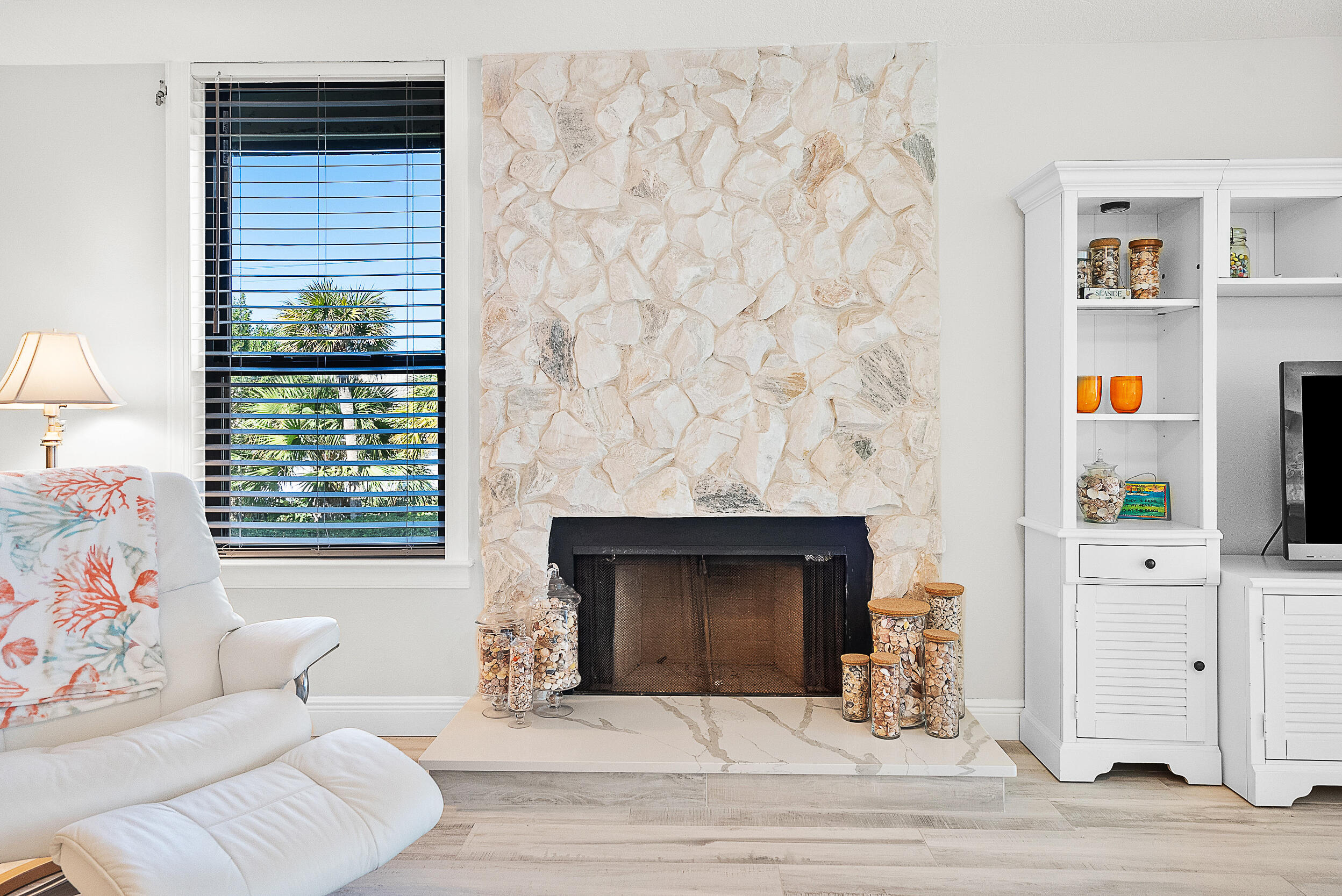 4100 North Hwy A1A, Unit 315 Hutchinson Island, FL 34949 - Photo 4 of 41 a living room with furniture and a fireplace