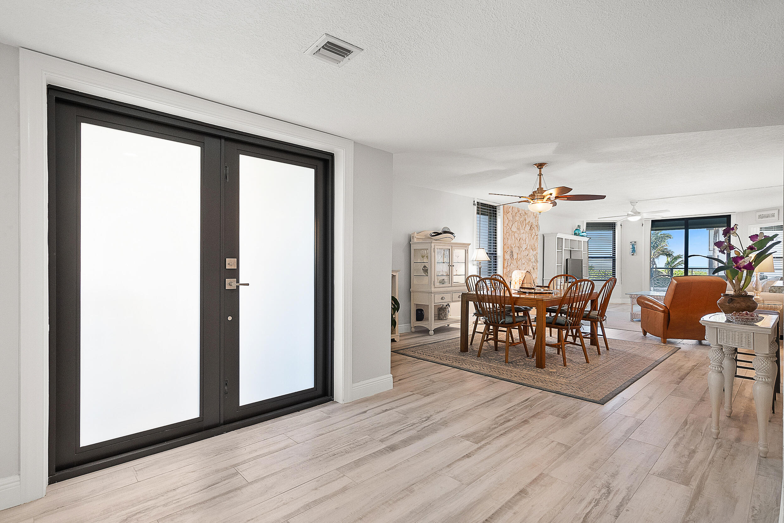 4100 North Hwy A1A, Unit 315 Hutchinson Island, FL 34949 - Photo 5 of 41 a view of a dining room with furniture and wooden floor