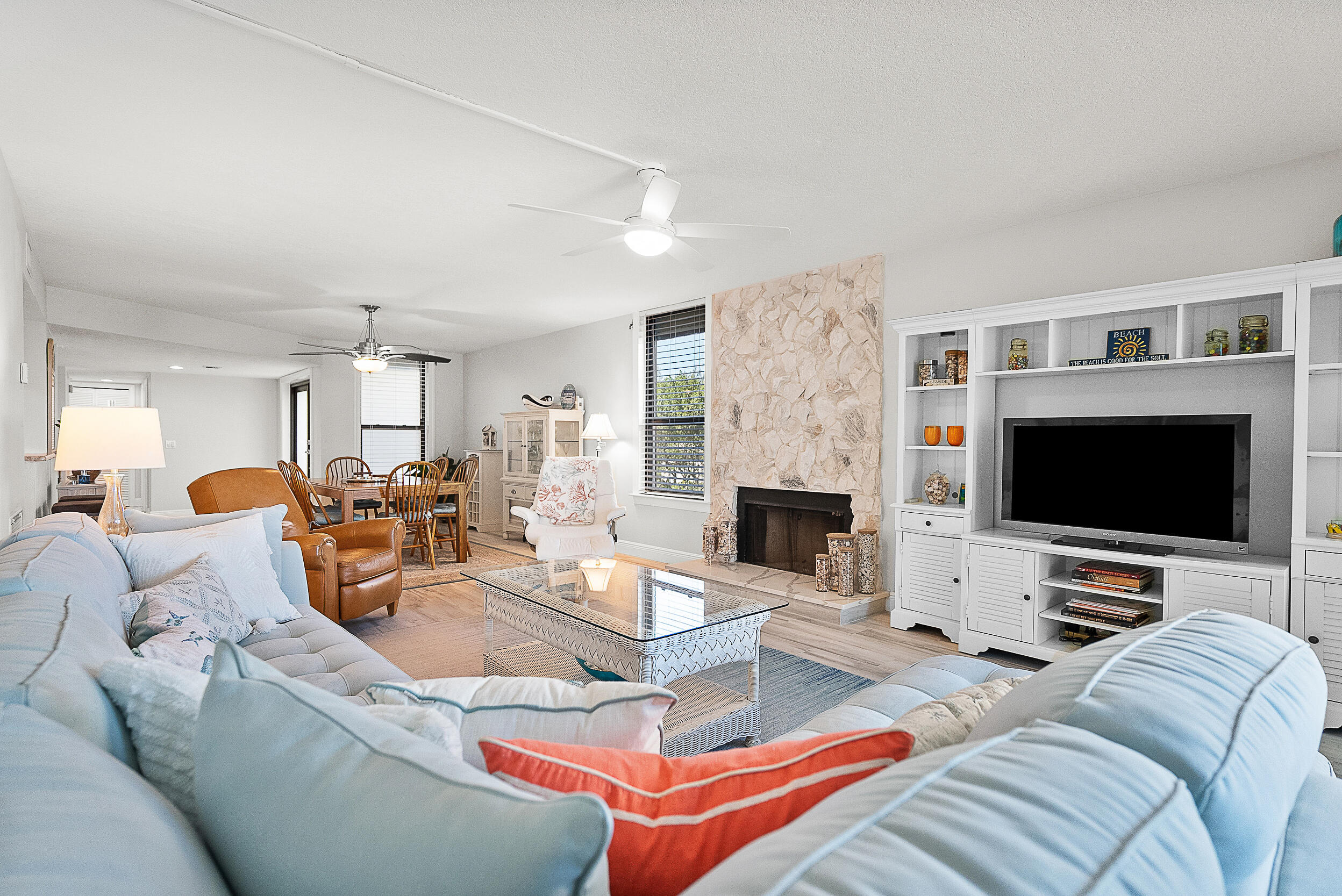 4100 North Hwy A1A, Unit 315 Hutchinson Island, FL 34949 - Photo 6 of 41 a living room with furniture a flat screen tv and a fireplace
