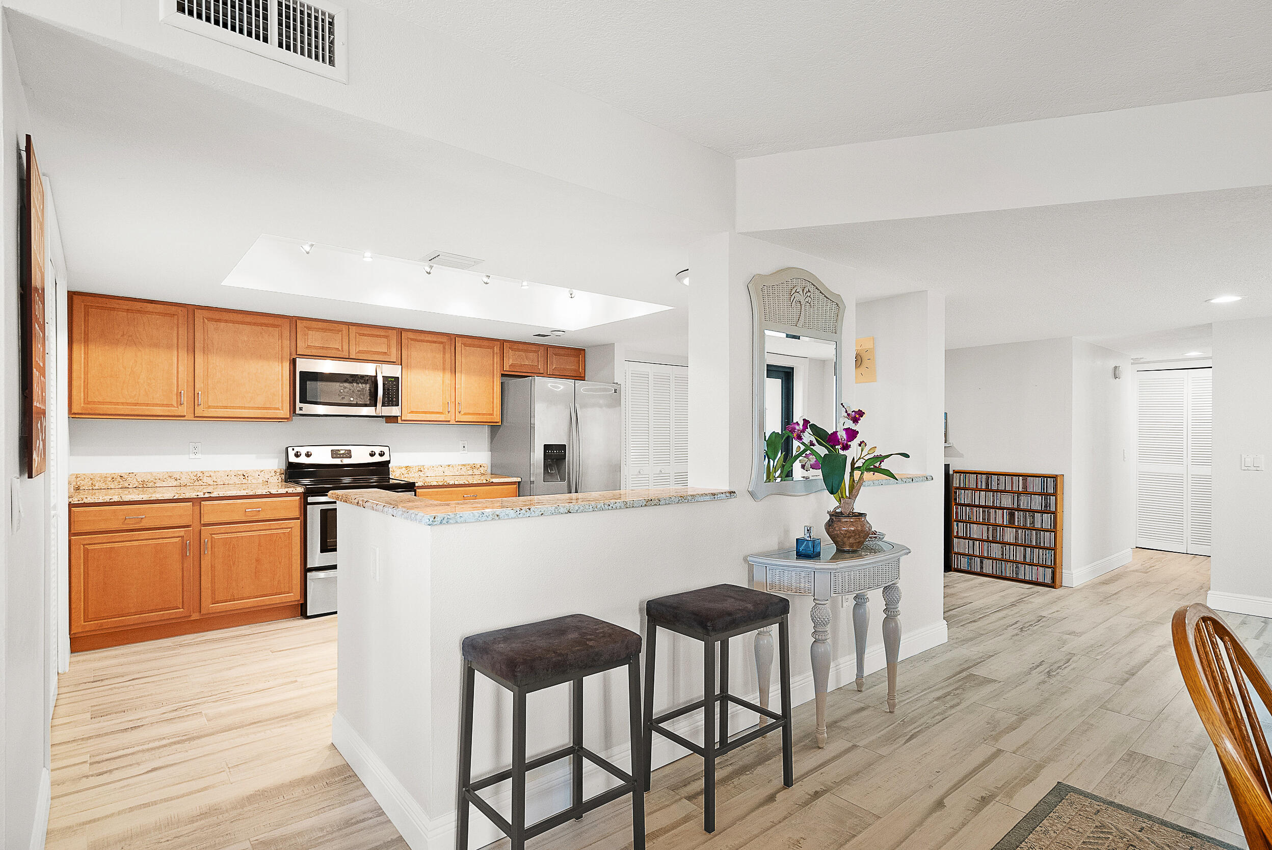 4100 North Hwy A1A, Unit 315 Hutchinson Island, FL 34949 - Photo 7 of 41 a kitchen with granite countertop appliances cabinets and furniture