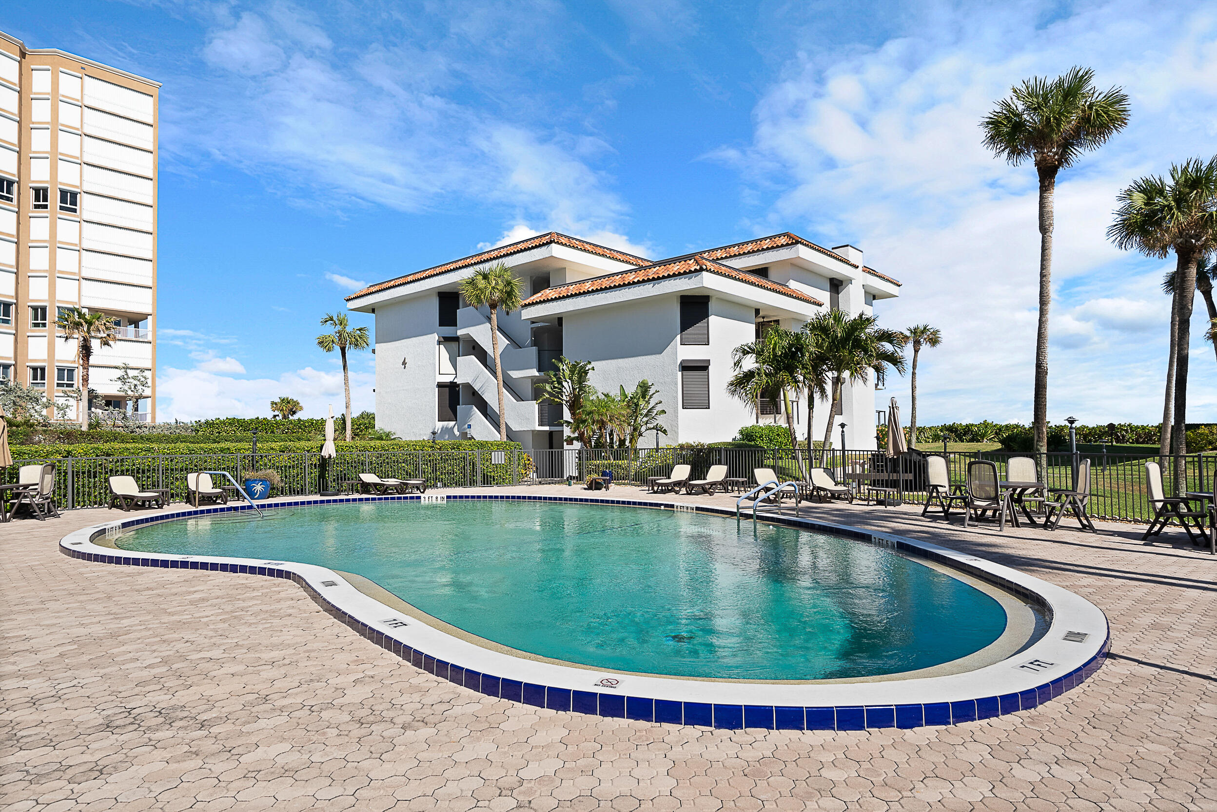 4100 North Hwy A1A, Unit 315 Hutchinson Island, FL 34949 - Photo 8 of 41 a view of a house with swimming pool and porch