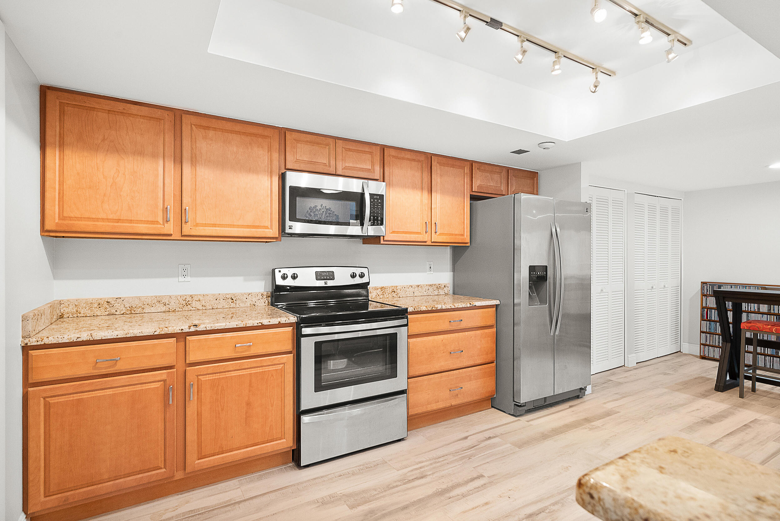 4100 North Hwy A1A, Unit 315 Hutchinson Island, FL 34949 - Photo 9 of 41 a kitchen with stainless steel appliances granite countertop a stove a refrigerator and a stove top oven