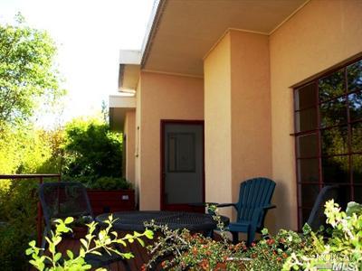 3266 Sullivan Road Sebastopol, CA 95472 - Photo 1 of 1 a wooden bench sitting in front of a house