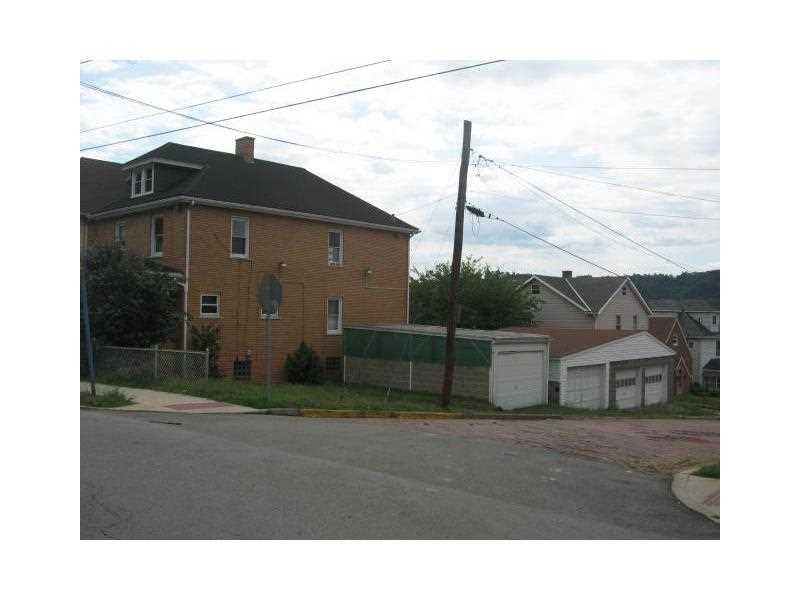 Exterior Front. Nice corner lot and yes 4 garages!