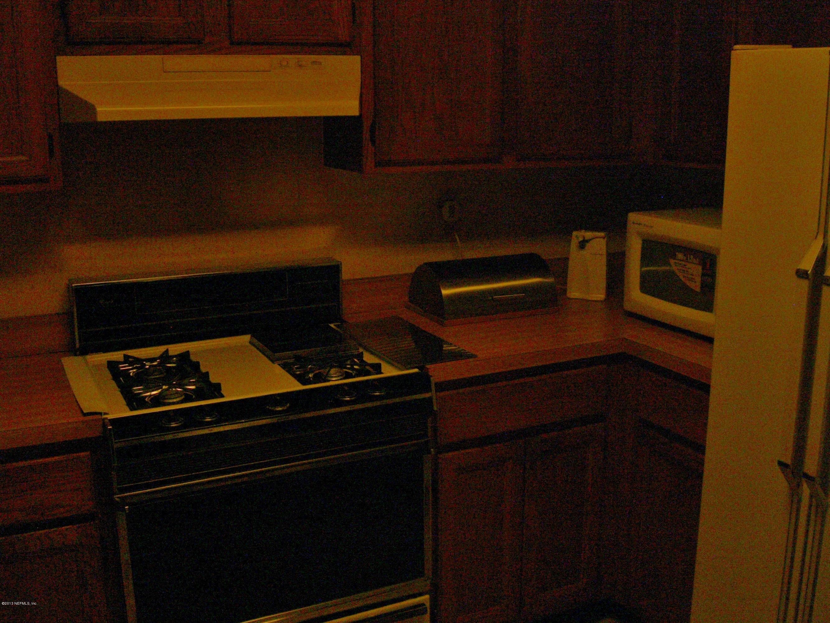 309 Royal Road St. Augustine, FL 32086 - Photo 4 of 5 a kitchen with a stove and a microwave