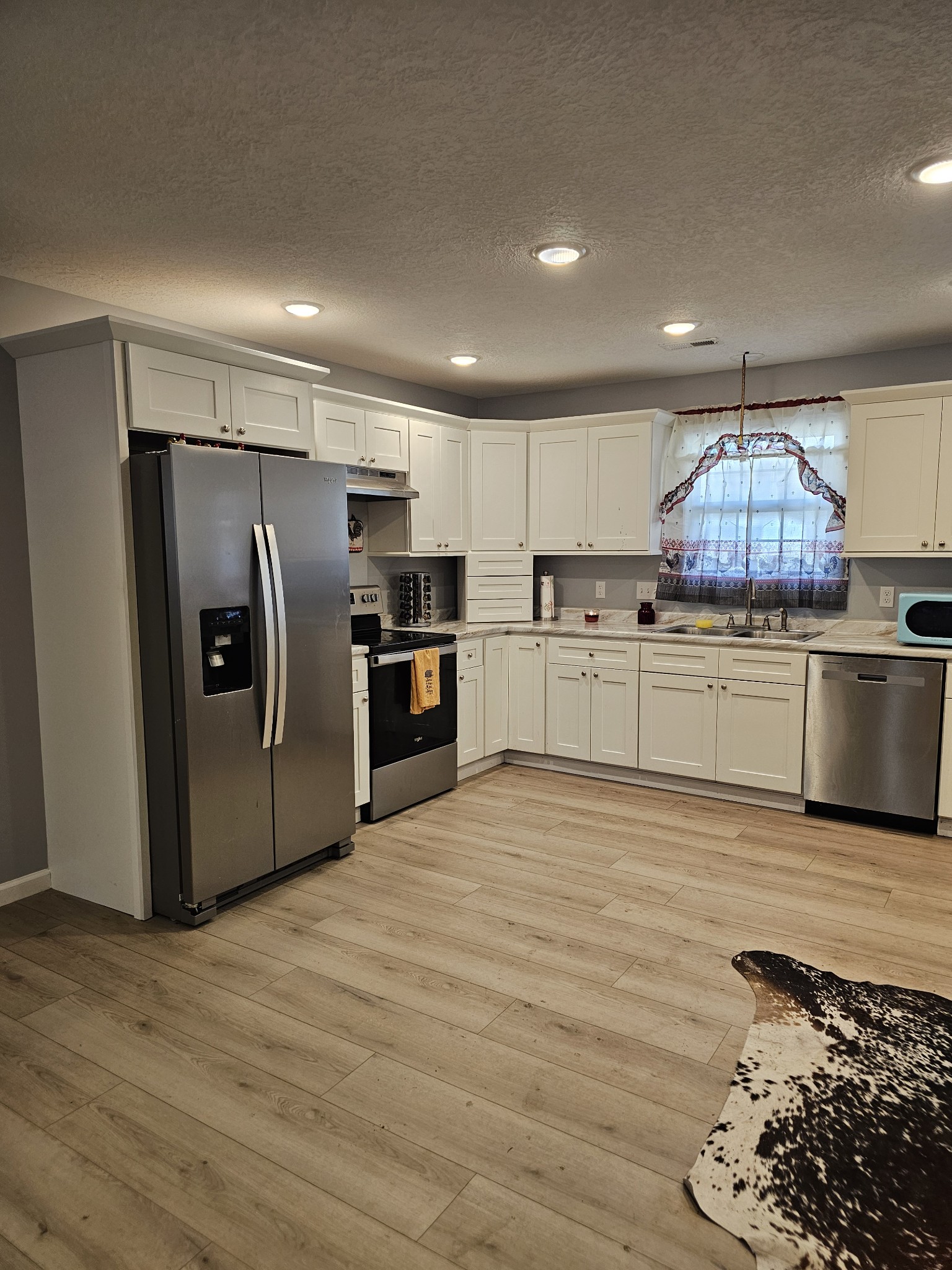 110 Water Street Big Sandy, TN 38221 - Photo 3 of 14 a kitchen with stainless steel appliances granite countertop a refrigerator sink and microwave