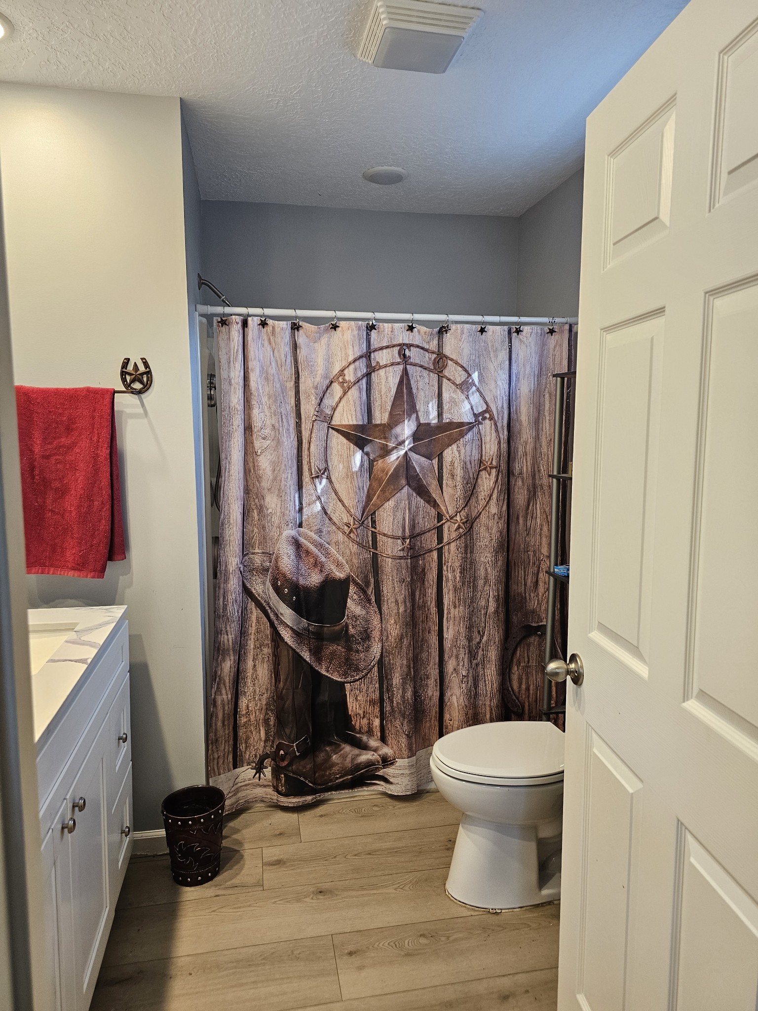 110 Water Street Big Sandy, TN 38221 - Photo 6 of 14 a bathroom with a toilet a sink and a shower