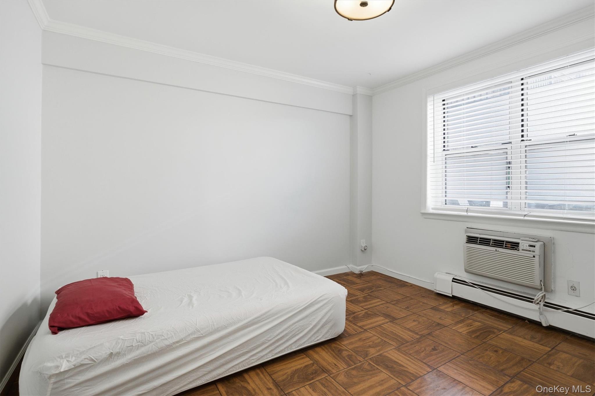 25 Chapel Place, Unit 1B Great Neck, NY 11021 - Photo 11 of 33 a bedroom with a bed and a window